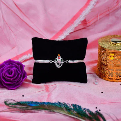 Stylish Ganesha Rakhi With Enamel Highlights And Silver Metal Chain - Zidbik