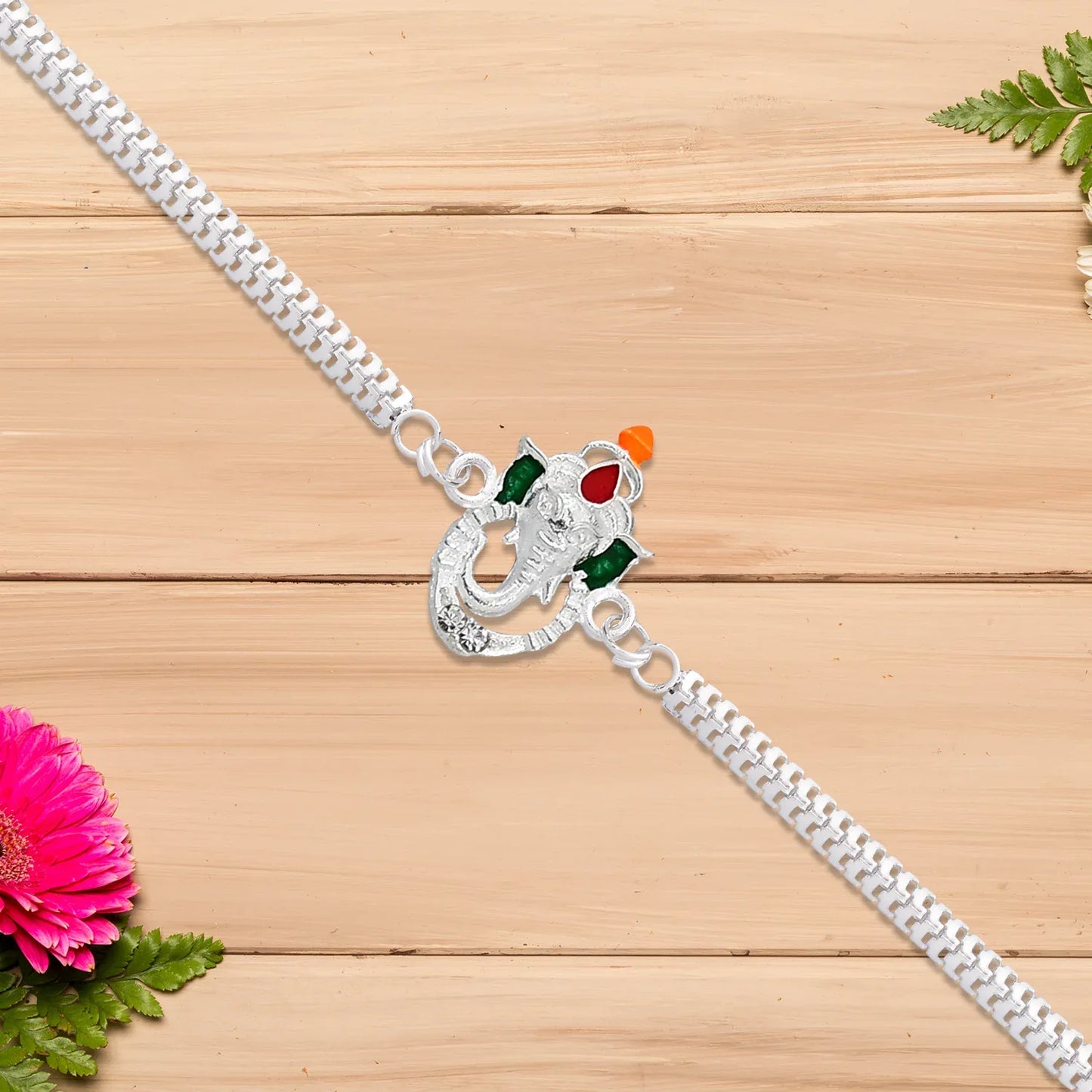 Stylish Ganesha Rakhi With Enamel Highlights And Silver Metal Chain - Zidbik